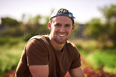 Buy stock photo Portrait of a handsome young farmer feeling confident and happy at his farm