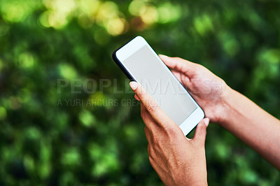 Buy stock photo Cropped shot of an unrecognizable female farmer using a cellphone outdoors at her farm