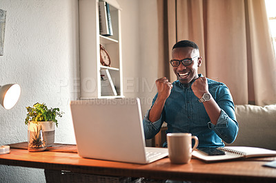 Buy stock photo Businessman reading good news on a laptop, looking excited and happy after a loan approval, winning a reward or an online sale while at home. Excited freelance worker with a cheerful expression