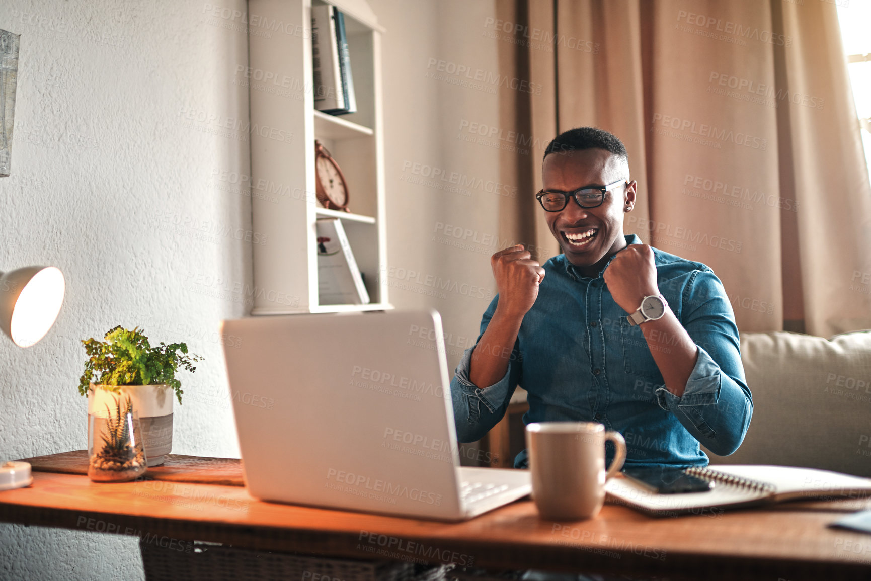 Buy stock photo Businessman reading good news on a laptop, looking excited and happy after a loan approval, winning a reward or an online sale while at home. Excited freelance worker with a cheerful expression