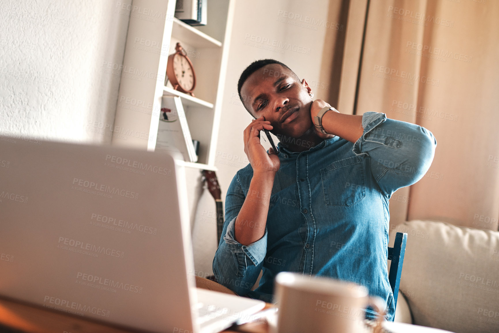 Buy stock photo Headache, stress and pain while talking on a phone call and working from a laptop at home. Worried, anxious man rushing to meet a deadline, looking unhappy while suffering from neck pain and tension