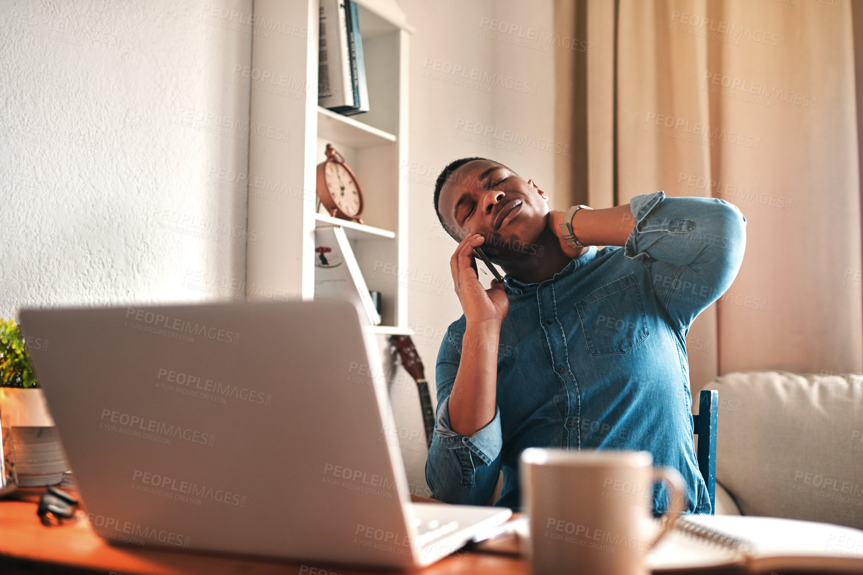 Buy stock photo Tired business man with neck pain on a laptop and phone call, looking stressed and stretching bad, strained muscle or sore back. Stressed, multitasking guy having a difficult time working from home