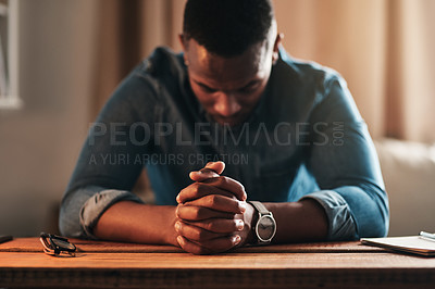 Buy stock photo Quiet, calm and spiritual man praying while kneeling with his hands clasped alone at home. Prayerful, spiritual and religious, Christian male saying a daily prayer in the morning in a bedroom  