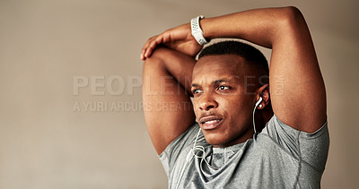 Buy stock photo Cropped shot of a sporty young man stretching at home
