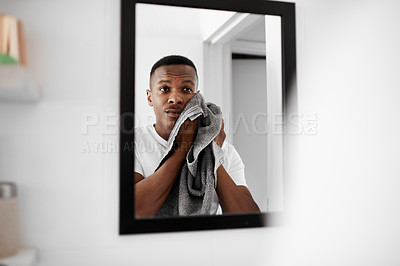 Buy stock photo Cropped shot of a man looking into the mirror while drying his face with a towel