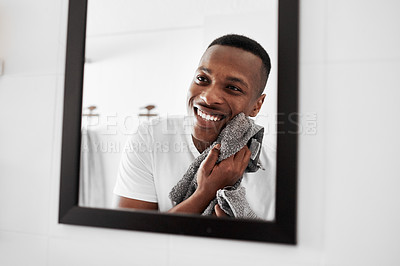 Buy stock photo Cropped shot of a man looking into the mirror while drying his face with a towel