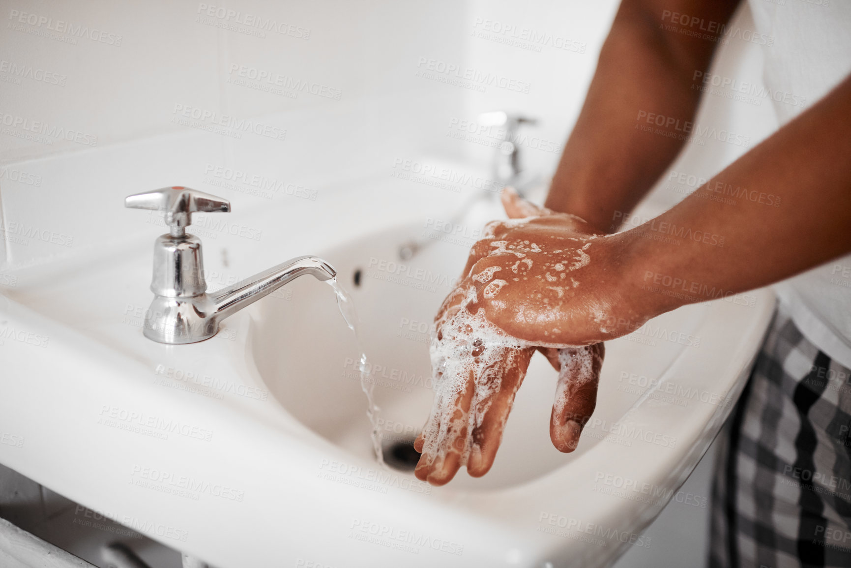 Buy stock photo Clean, hygiene and person washing hands in the bathroom with soap for wellness, health and bacteria prevention. Protection, home and man cleaning hand with water in his apartment as morning routine