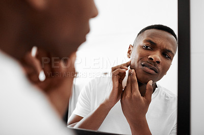 Buy stock photo Cropped shot of a young man squeezing pimples in the bathroom mirror