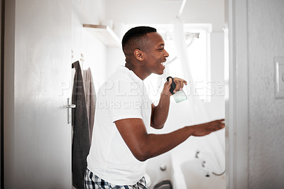 Buy stock photo Shot of a man singing in the bathroom while getting ready