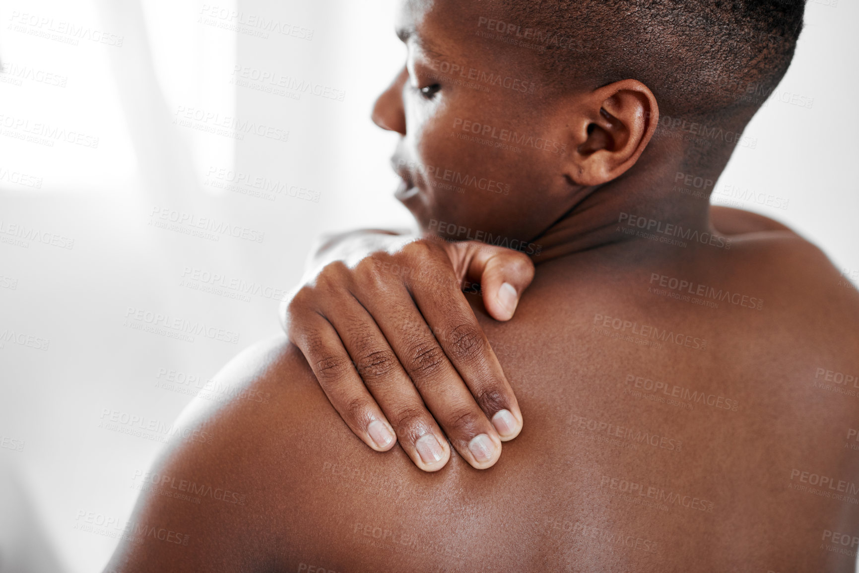 Buy stock photo Cropped shot of a man suffering from shoulder pain