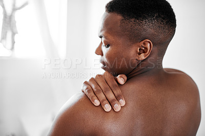 Buy stock photo Cropped shot of a man suffering from shoulder pain