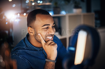 Buy stock photo Shot of a young businessman working on a computer in an office at night