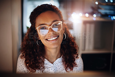 Buy stock photo Portrait of a young businesswoman working on a computer in an office at night