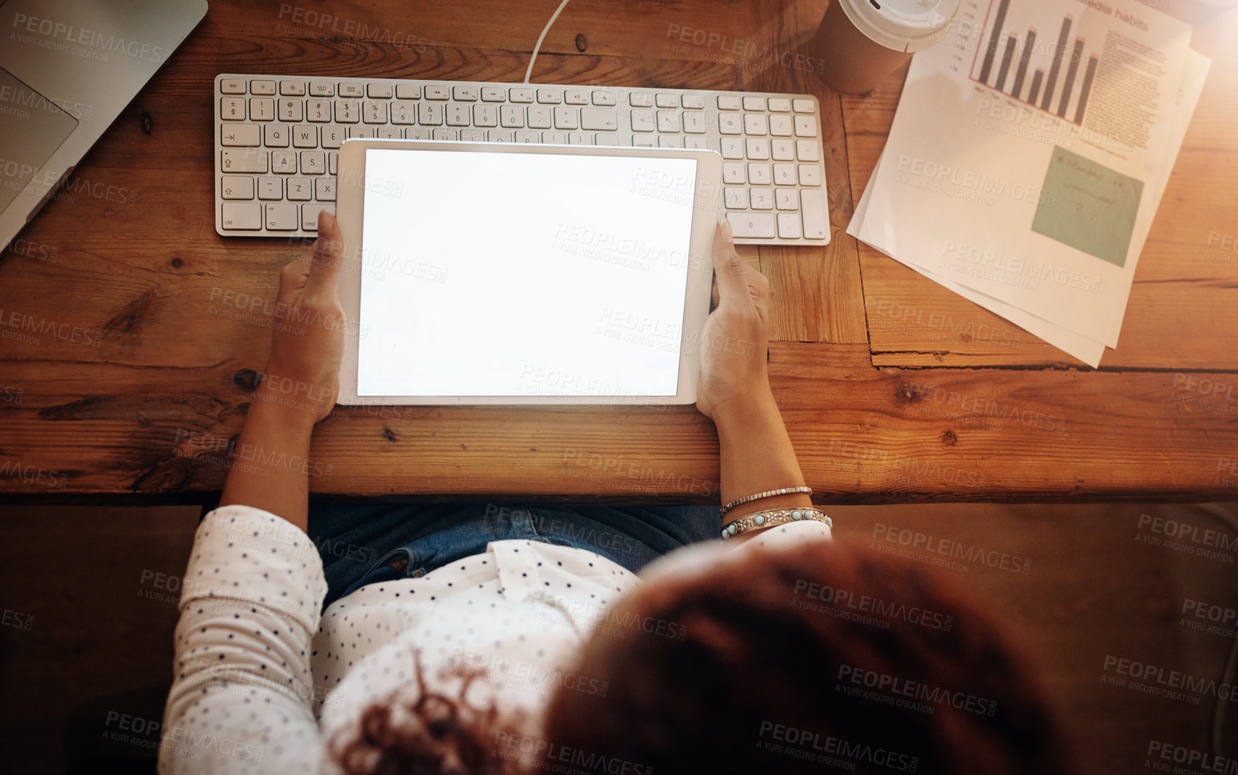 Buy stock photo High angle shot of an unrecognisable businesswoman using a digital tablet in an office at night