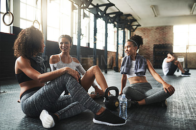 Buy stock photo Shot of a group of happy young women taking a break together at the gym