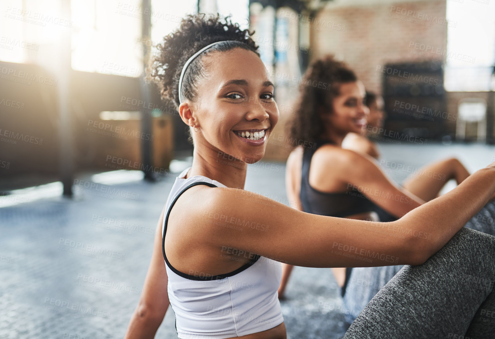 Buy stock photo Shot of a group of happy young women taking a break together at the gym