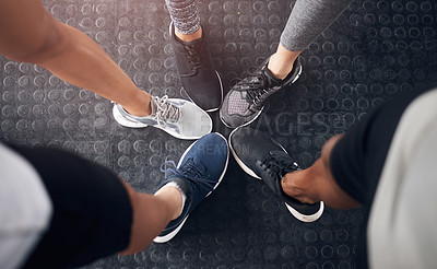 Buy stock photo Fitness, group or huddle with shoes at gym in circle for teamwork, workout or unity at indoor health club. Top view, closeup or active people with feet or sneakers for motivation or exercise together