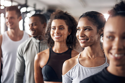 Buy stock photo Shot of a group of young people standing together in a line at the gym