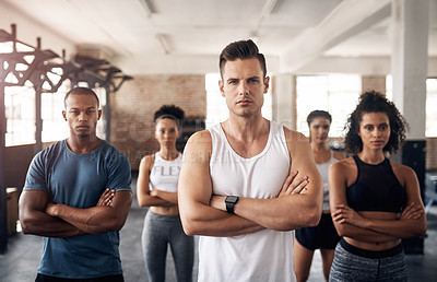 Buy stock photo Portrait of a group of confident young people working out together in a gym