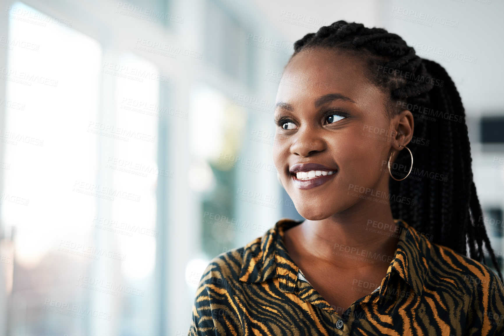 Buy stock photo Cropped shot of an attractive young businesswoman standing alone in her office during the day