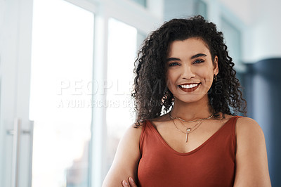 Buy stock photo Cropped portrait of an attractive young businesswoman standing alone in her office during the day