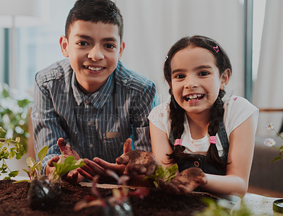 Buy stock photo Cropped portrait of two adorable young siblings smiling while doing some gardening at home