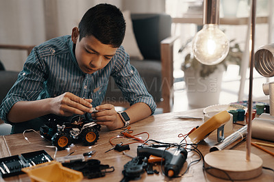 Buy stock photo Learning, car robot and kid in home with homework, homeschool and science for tech project. Robotics, building and boy child with electrical knowledge, engineering education and studying in house.