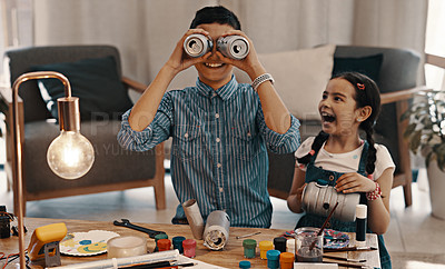 Buy stock photo Shot of two adorable young siblings having fun and building a robot together at home