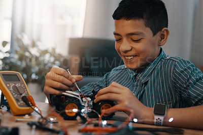 Buy stock photo Education, car robot and smile of child with homework, homeschool and science, learning and tech project. Robotics, building and boy kid with electrical knowledge, engineering and studying in house.
