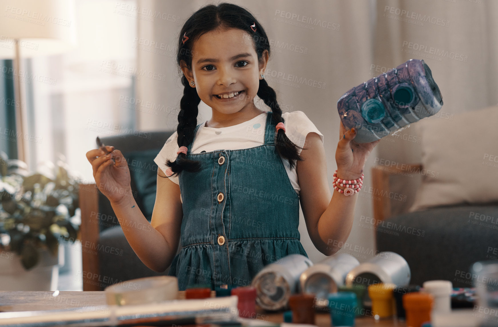 Buy stock photo Portrait of an adorable young painting and building a toy robot at home