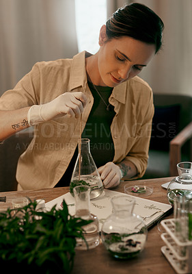 Buy stock photo Shot of an attractive young botanist studying and experimenting with water grown plants in her office