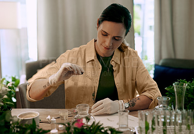 Buy stock photo Shot of an attractive young botanist adding a liquid nutrient to a water based plant inside a test tube