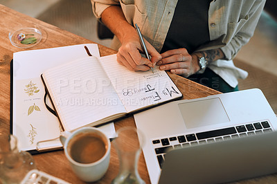 Buy stock photo Cropped shot of an unrecognizable botanist doing research and writing notes in her diary at work