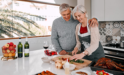 Buy stock photo Shot of a mature couple preparing a Thanksgiving meal at home