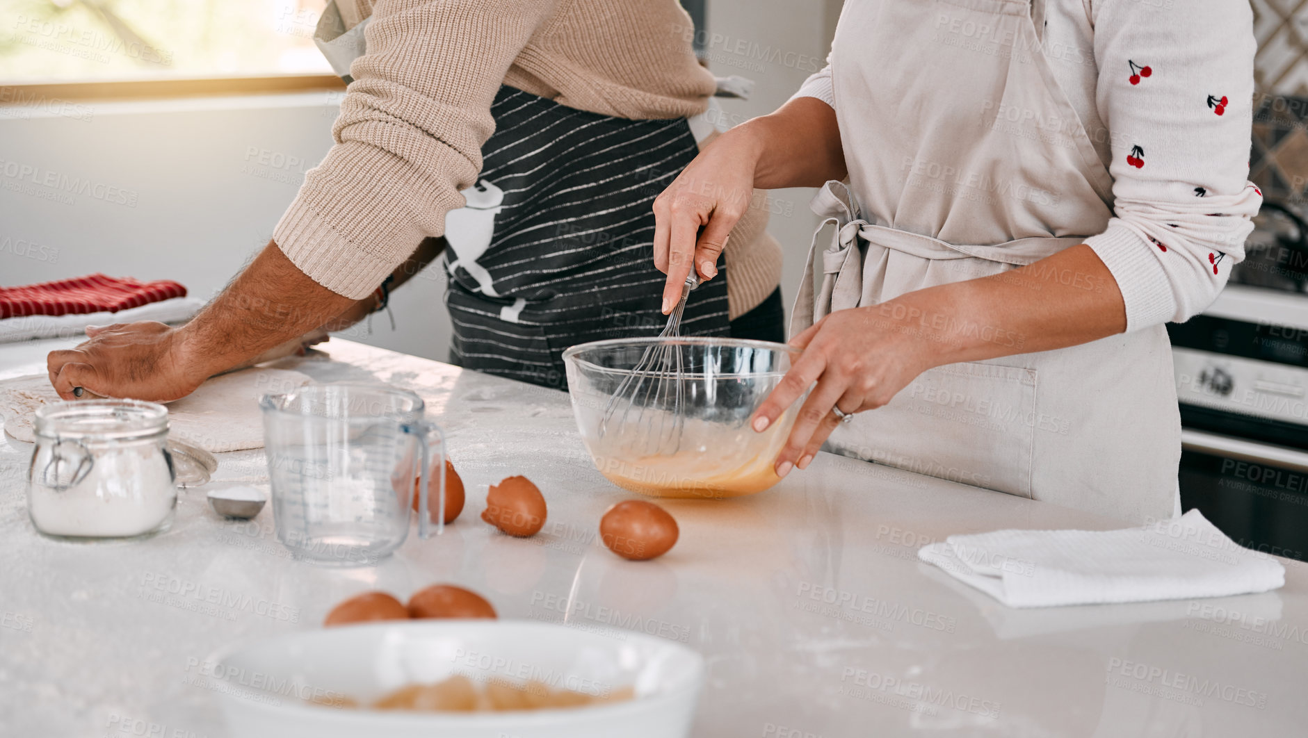 Buy stock photo Cropped shot of a couple baking together at home