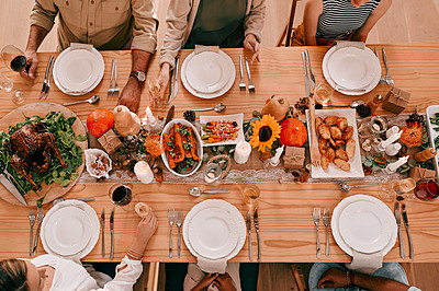 Buy stock photo High angle shot of a group of friends having a Thanksgiving meal together