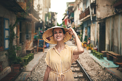 Buy stock photo Shot of a young woman walking through the streets of Vietnam