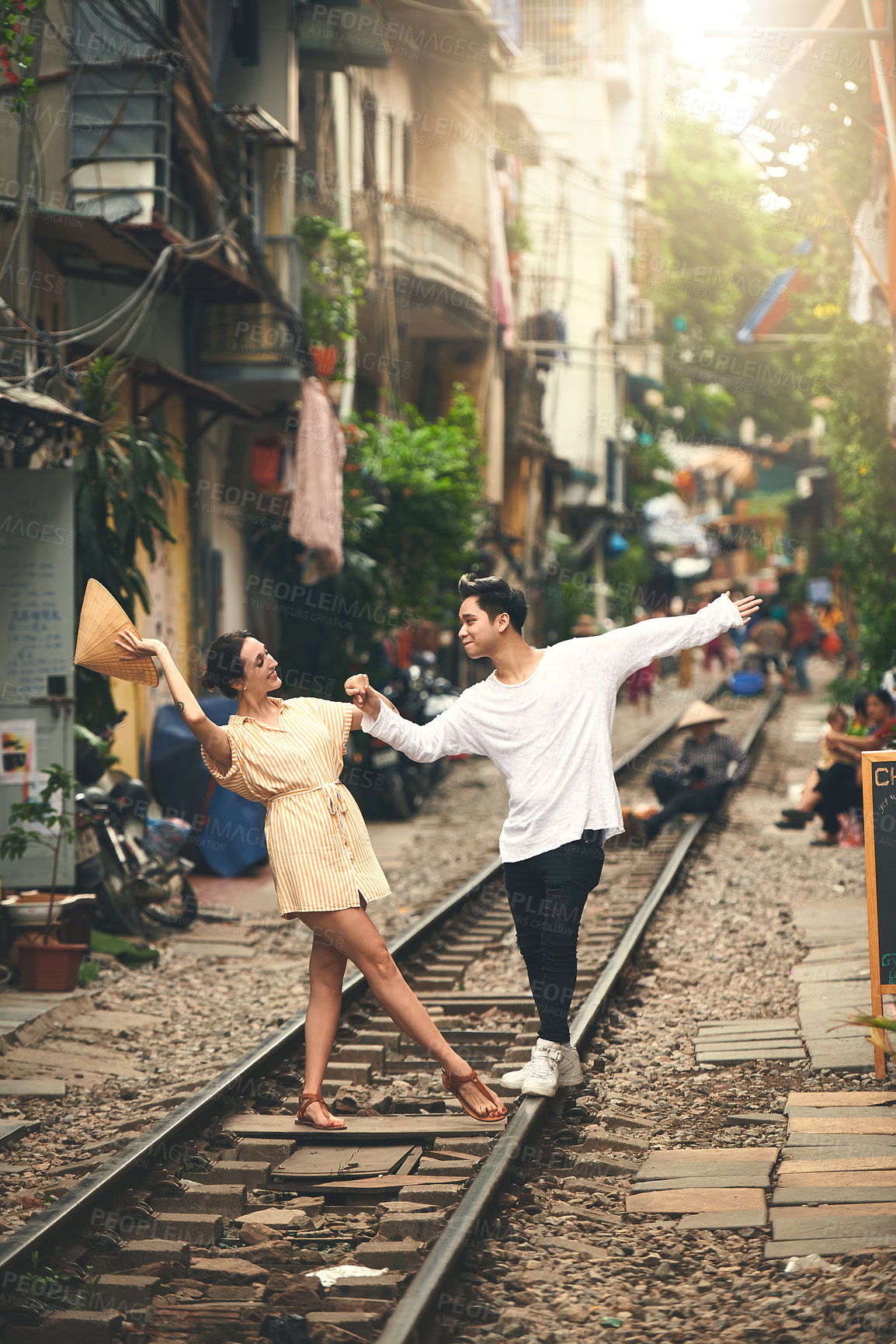 Buy stock photo Dance, city and couple by railway in Vietnam for holiday, vacation and tourist destination. Dating, love and happy man and woman on train tracks for adventure, journey and travel for bonding together