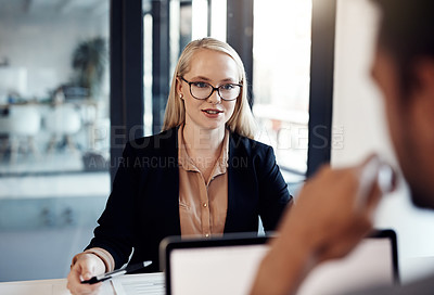 Buy stock photo Shot of a young businessman and businesswoman having a discussion in the boardroom of a modern office