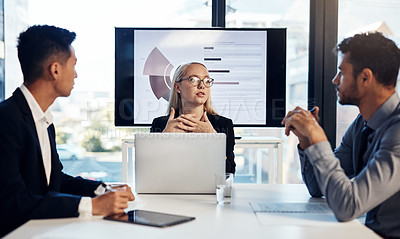 Buy stock photo Shot of a group of young businesspeople having a meeting in the boardroom of a modern office