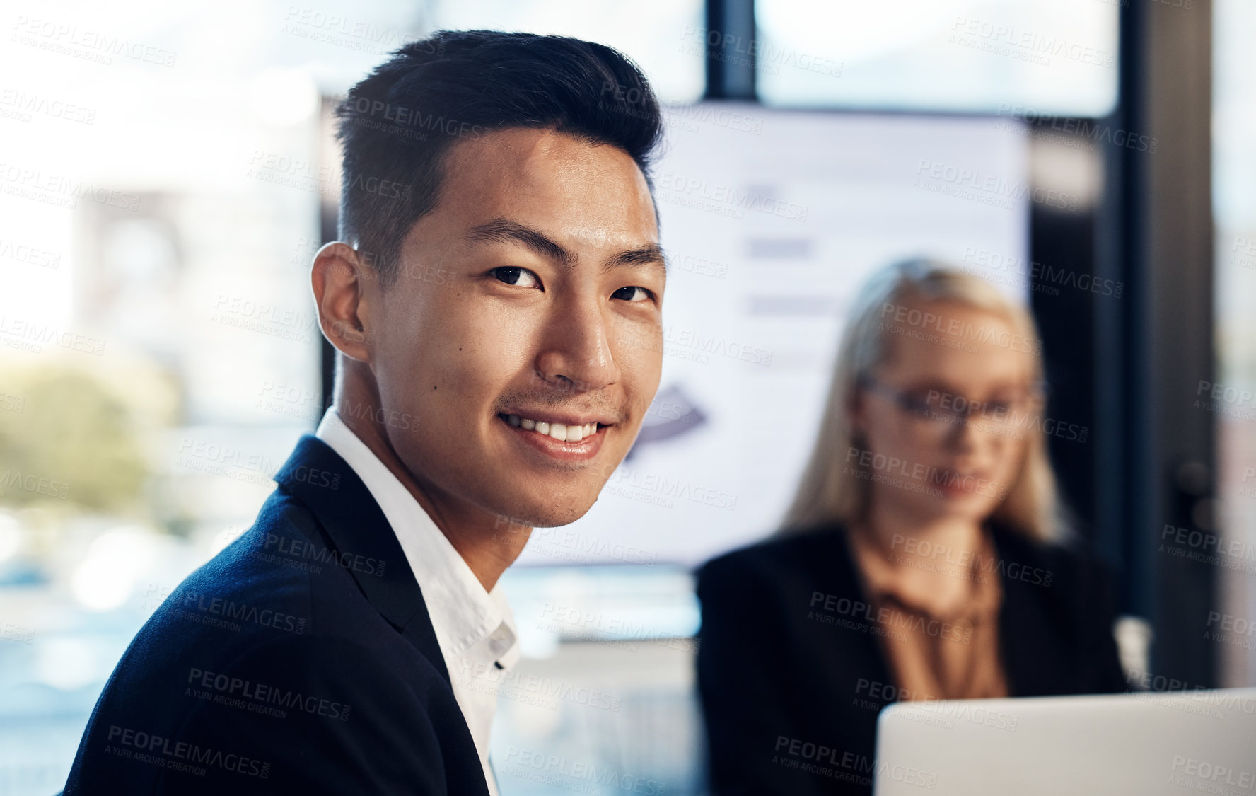 Buy stock photo Portrait of a confident young businessman having a meeting with colleagues in the boardroom of a modern office