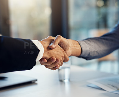 Buy stock photo Cropped shot of two businessmen shaking hands during a meeting in a modern office
