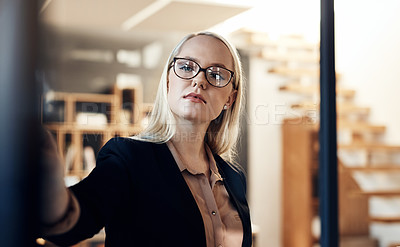 Buy stock photo Shot of a confident young businesswoman having a brainstorming session in a modern office