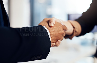 Buy stock photo Cropped shot of a businesswoman and businessman shaking hands during a meeting in a modern office