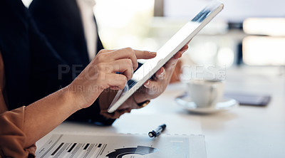 Buy stock photo Cropped shot of a businesswoman using a digital tablet during a meeting in the boardroom of a modern office