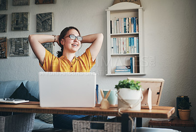 Buy stock photo Cropped shot of an attractive young businesswoman sitting alone in her home office with her hands behind her head