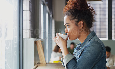 Buy stock photo Shot of an attractive young woman drinking coffee in a cafe