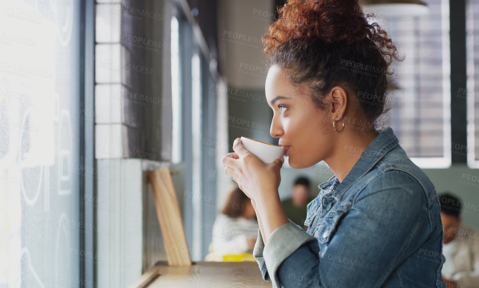 Buy stock photo Shot of an attractive young woman drinking coffee in a cafe