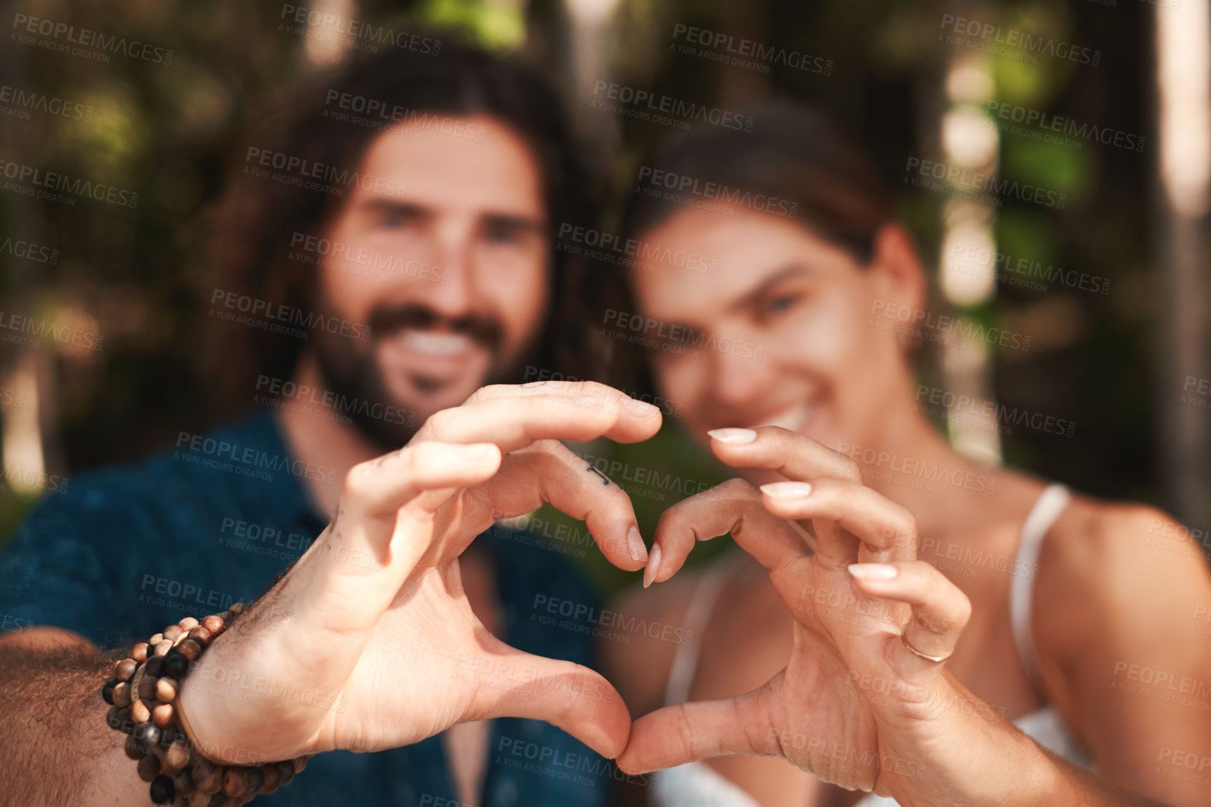 Buy stock photo Couple, hands and heart with smile, happy and love for together, bonding and romance in outdoor. Woman, man and shape for honeymoon, vacation or holiday in summer for weekend, getaway and adventure