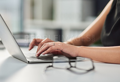 Buy stock photo Cropped shot of an unrecognizable businesswoman working on a laptop in her office